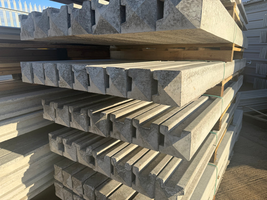 Stack of concrete corner and end posts, bags of postmix and concrete gravel boards professionally delivered by Romford Fencing Ltd