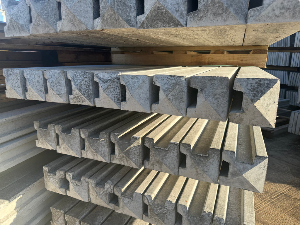 Stack of concrete corner and end posts, bags of postmix and concrete gravel boards professionally delivered by Romford Fencing Ltd