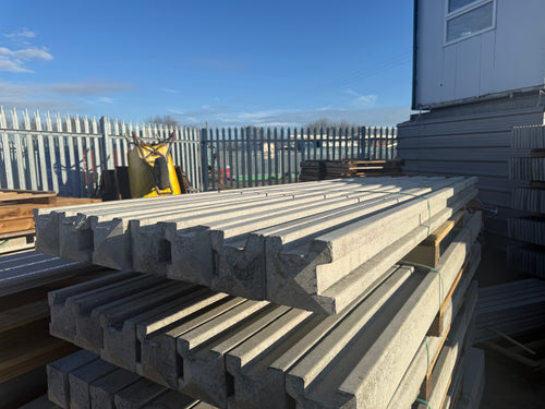 Stack of concrete corner and end posts, bags of postmix and concrete gravel boards professionally delivered by Romford Fencing Ltd