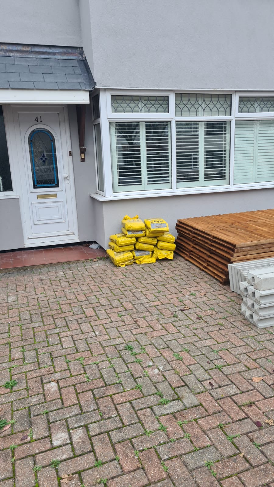 Stack of concrete posts, bags of postmix and concrete gravel boards professionally delivered by Romford Fencing Ltd